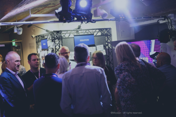 Strategic. Delegates gathering in a breakout at a corporate event.