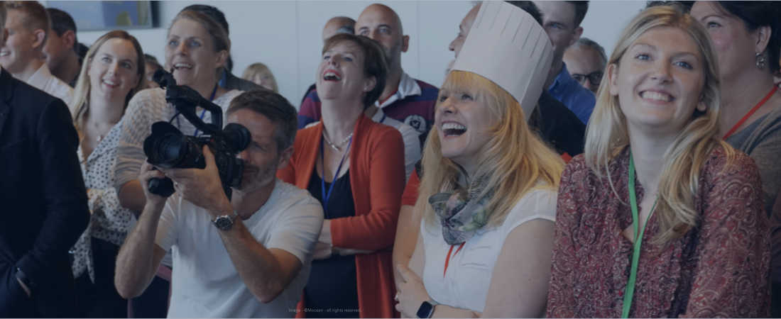 Delegates engaging in a crowd at a corporate event.